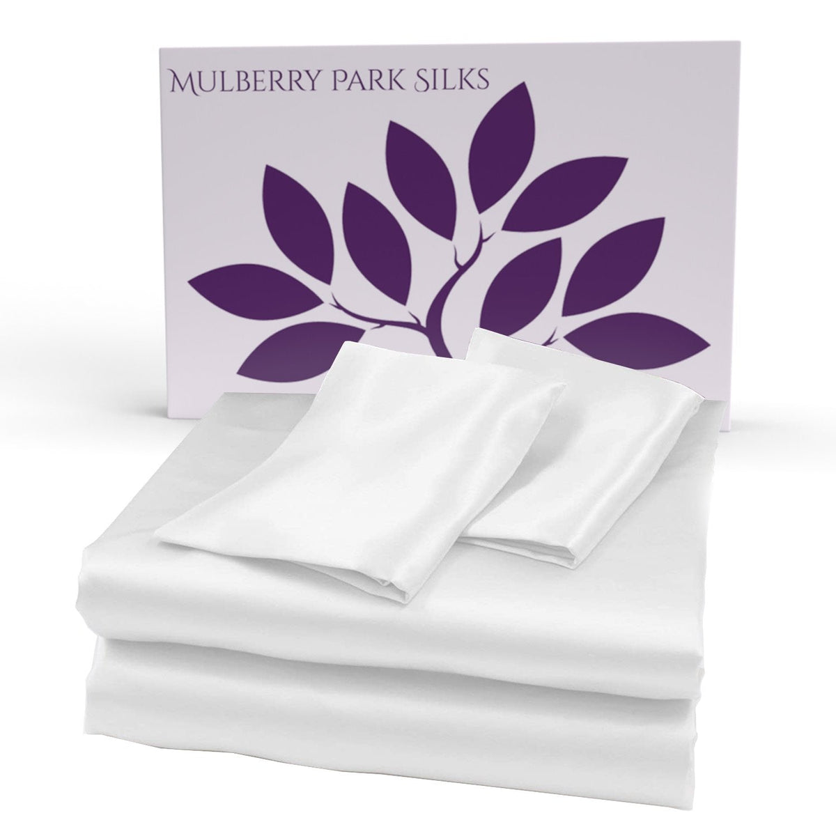 White silk sheet set displayed in front of a Mulberry Park Silks box with a purple leaf logo