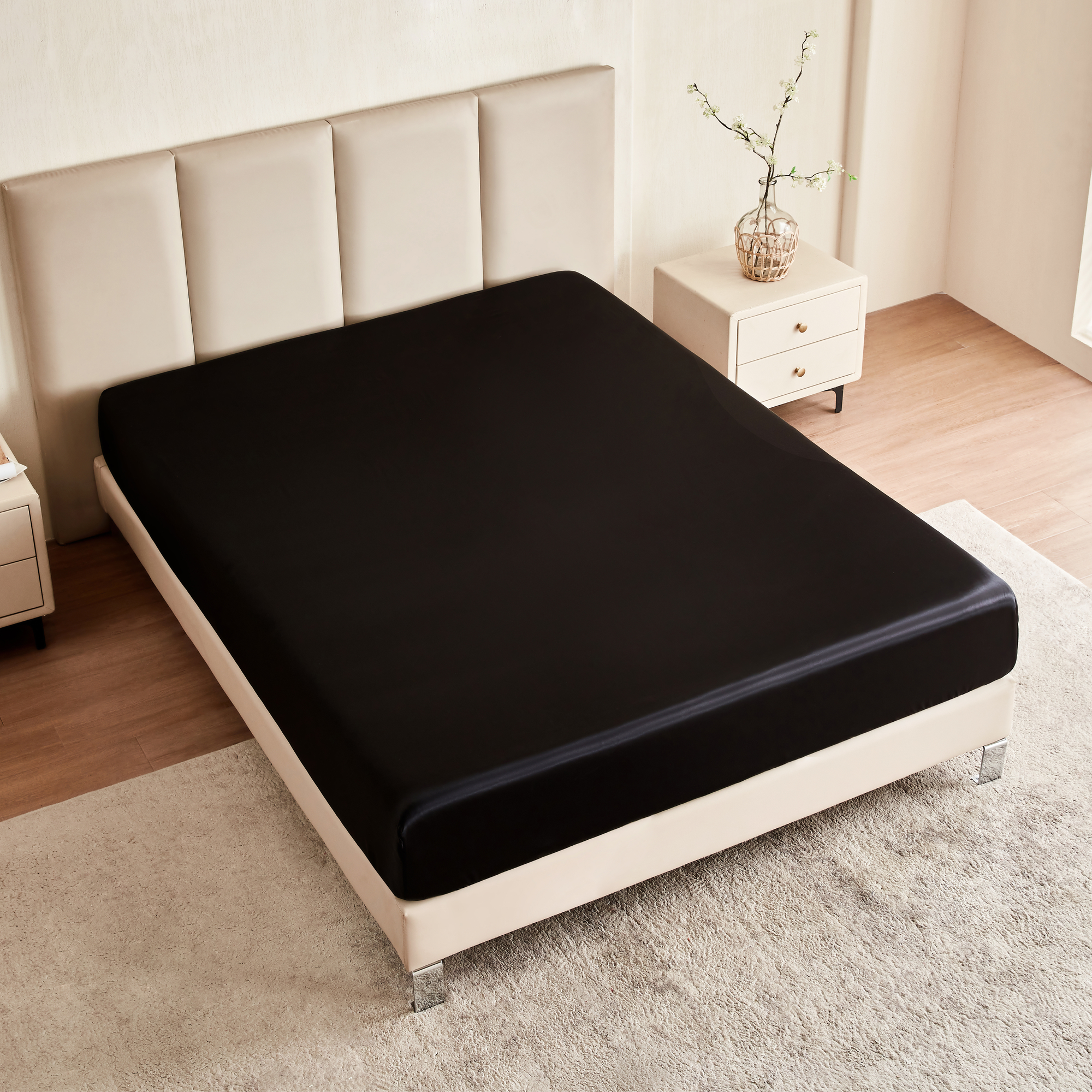 Black fitted sheet on a bed in a bedroom setting