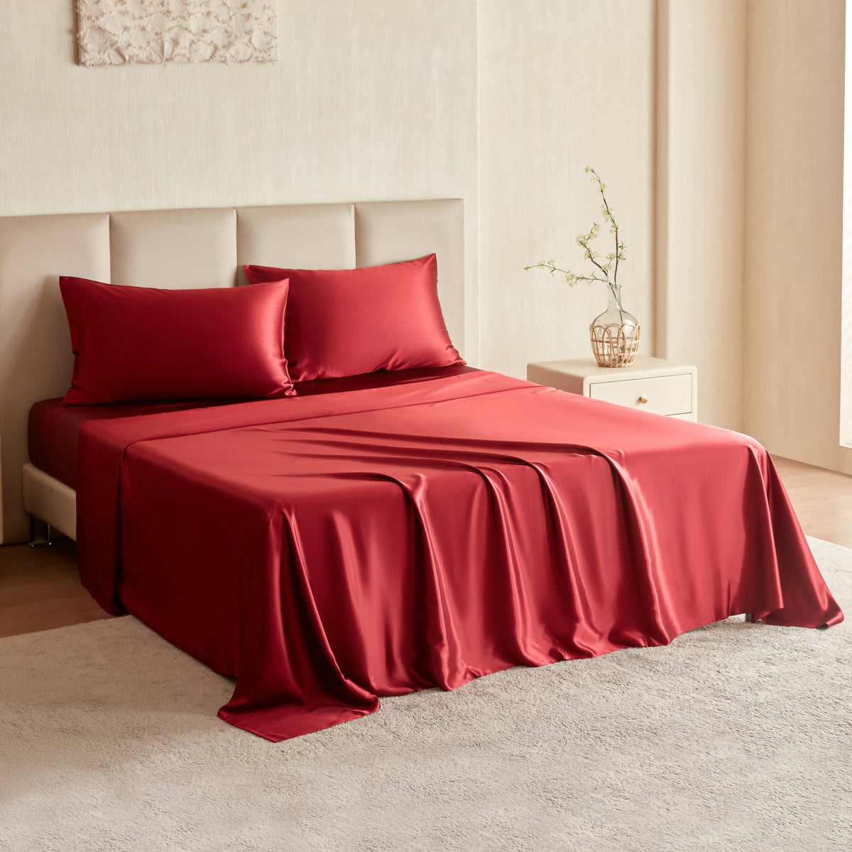 Red mulberry silk sheet set on a bed in a bedroom setting