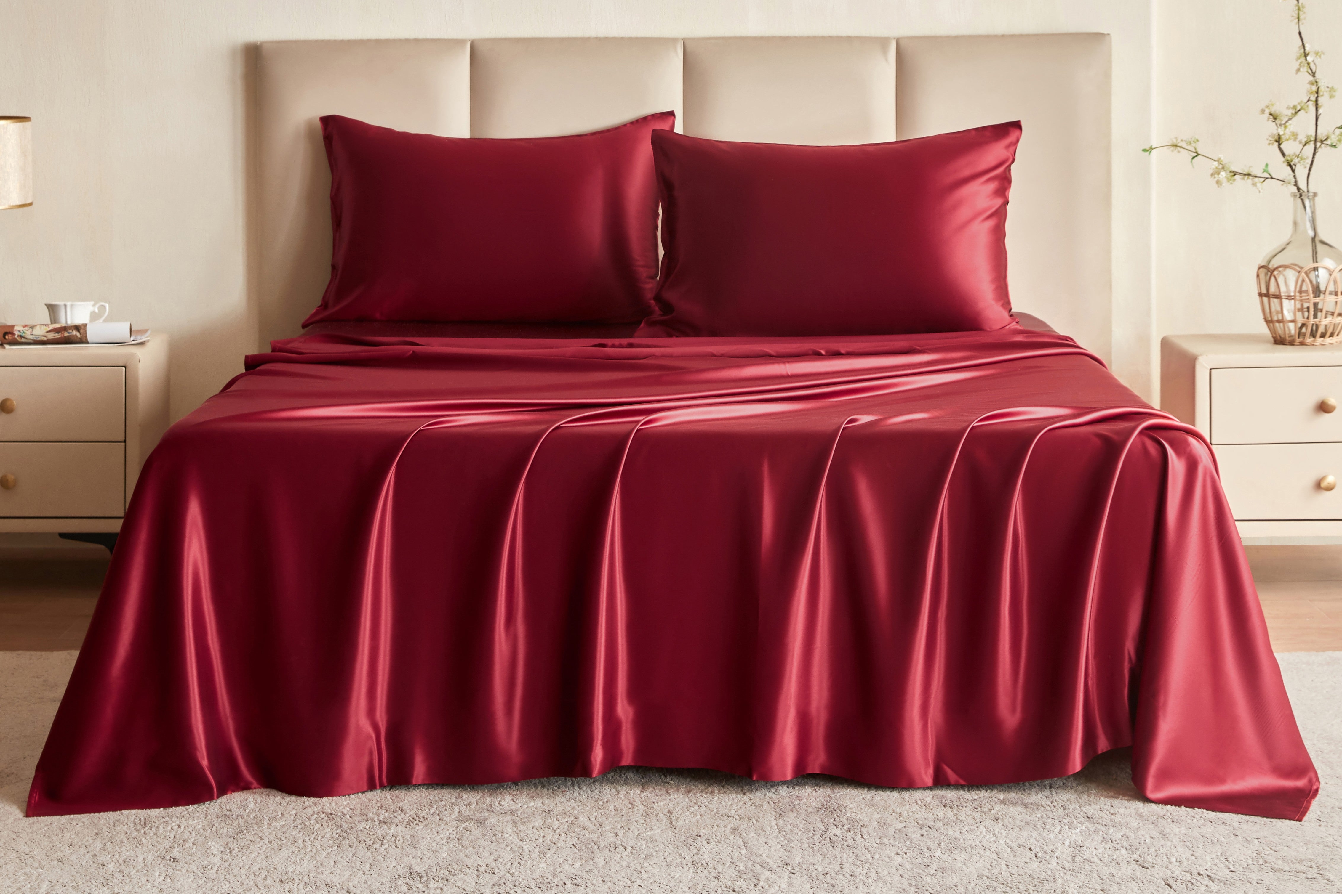Wine Red Silk bedding set on a bed in a bedroom setting